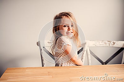 Happy cute toddler girl playing at home in kitchen Stock Photo