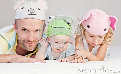 Happy dad with kids in funny hats Stock Photo