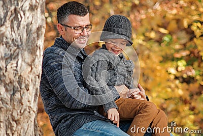 Father and son playing together outdoors in the park Stock Photo