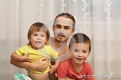 Happy dad with two playful kids Stock Photo