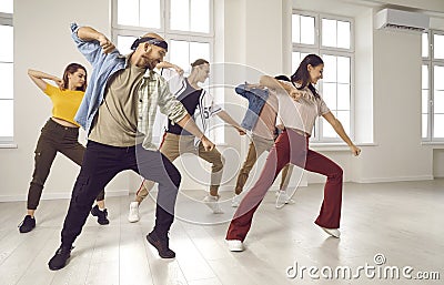 Happy dancers group train dance together in studio Stock Photo
