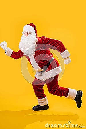 Happy dancing Santa Claus doing a version of a walking man move Stock Photo