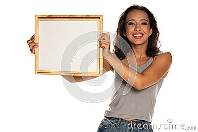 Happy dark skinned woman holding empty whiteboard Stock Photo