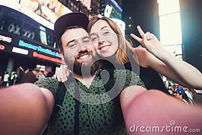 Happy dating couple in love taking selfie photo on Times Square in New York while travel in USA on honeymoon Stock Photo