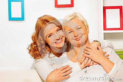 Happy daughter and eldery mother hug with smils Stock Photo