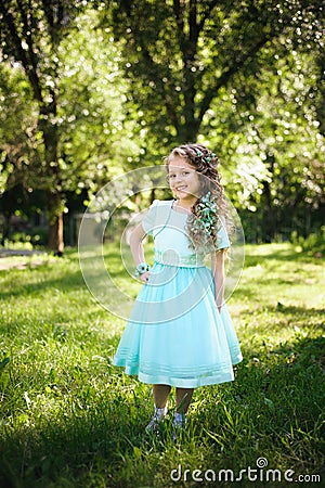 Happy daughter smiling at camera in summer park Stock Photo