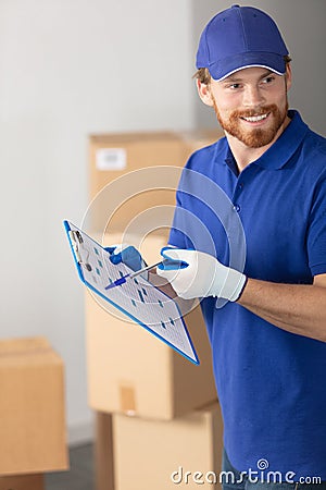 happy delivery man with cardboard box checking list Stock Photo