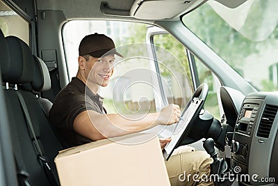 Happy Delivery Man Checking List Stock Photo