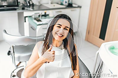 Happy dental patient in the dental clinic Stock Photo