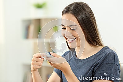 Happy diabetic girl checking blood sugar level Stock Photo