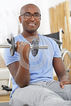 Happy disable man with dumbbells Stock Photo