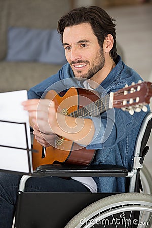 happy disable man playing guitar Stock Photo