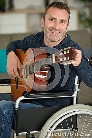 happy disable man playing guitar Stock Photo