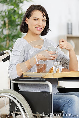 happy disable woman having healthy breakfast Stock Photo