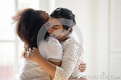 Happy diverse best friends hugging and laughing, sudden meeting Stock Photo