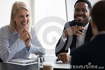 Happy diverse business leaders of different ages meeting with partners Stock Photo