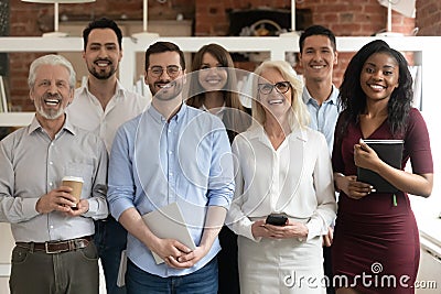 Happy diverse business team standing in office looking at camera Stock Photo