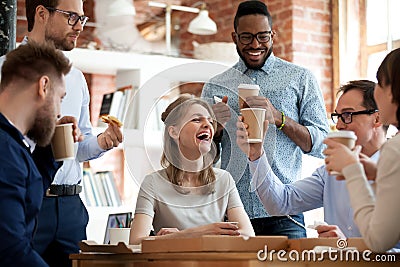 Happy diverse colleagues celebrate during lunch break in office Stock Photo