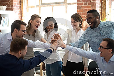 Happy diverse colleagues give high five together celebrate great teamwork Stock Photo