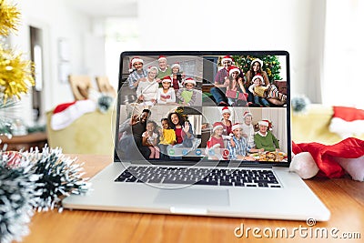 Happy diverse families smiling on laptop group video call screen at christmas time Stock Photo