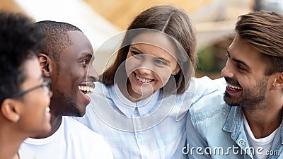 Happy diverse friends talking embracing gathering outdoors at reunion meeting Stock Photo