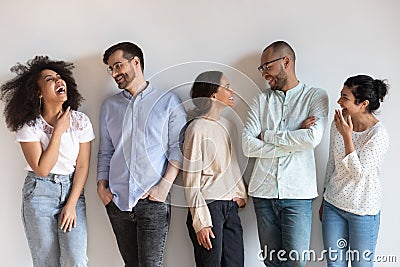 Happy diverse people having fun, talking, standing in row Stock Photo