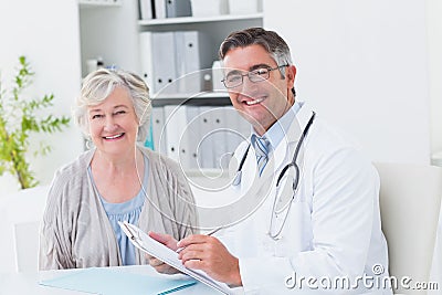 Happy doctor and female patient in clinic Stock Photo