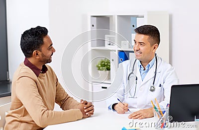 Happy doctor and male patient meeting at clinic Stock Photo