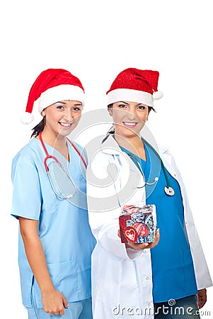 Happy doctors women giving Christmas gift Stock Photo