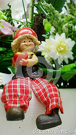 Happy doll in the flower garden Stock Photo