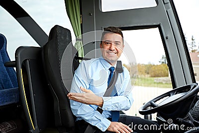 Happy driver inviting on board of intercity bus Stock Photo