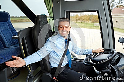 Happy driver inviting on board of intercity bus Stock Photo