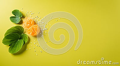 Happy Dussehra background concept. Green leaf and rice on yellow pastel background. Dussehra Indian Festival concept Stock Photo