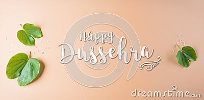 Happy Dussehra. Green leaf with the text on orange pastel background. Dussehra Indian Festival concept Stock Photo