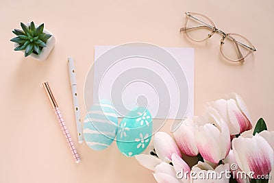 Happy Easter concept with blank card and colorful easter eggs and pink tulips Stock Photo