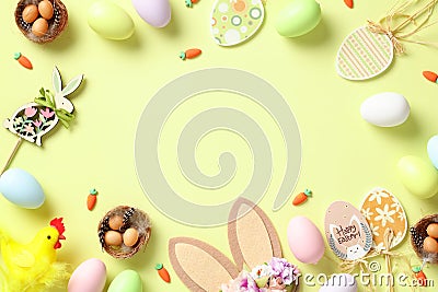 Happy Easter concept. Frame of Easter eggs, rabbit, bunny ears, wooden eggs decorations on green background Stock Photo