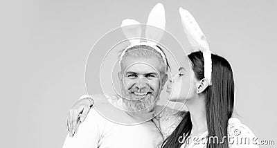 Happy Easter couple kissing, bunny rabbit woman and man hold board paper. Funny Easter bunny couple on blue background Stock Photo