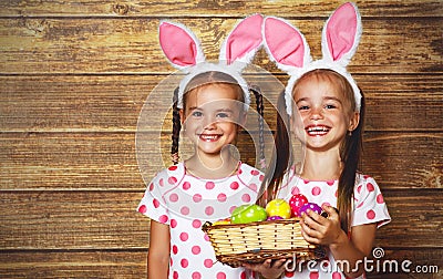 Happy easter! cute twins girls sisters dressed as rabbits with e Stock Photo