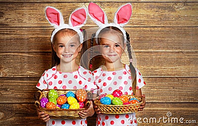 Happy easter! cute twins girls sisters dressed as rabbits with e Stock Photo