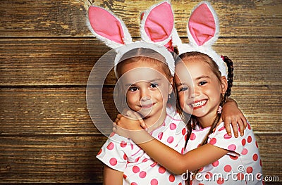 Happy easter! cute twins girls sisters dressed as rabbits on wo Stock Photo