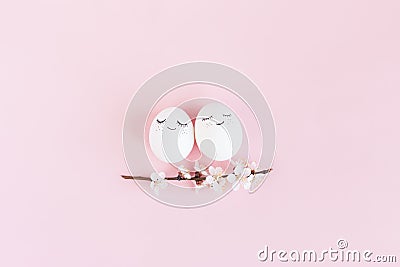 Happy easter eggs with spring blossom on a pastel pink background Stock Photo