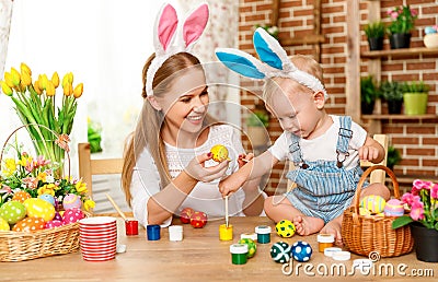 Happy easter! family mother and baby son paint eggs for holiday Stock Photo