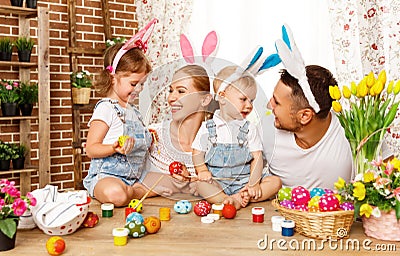 Happy easter! family mother, father and children paint eggs for Stock Photo