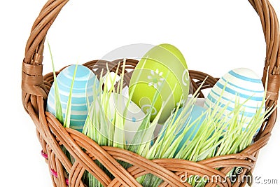 Happy Easter - few eggs on the wooden basket with a grass on the white background Stock Photo