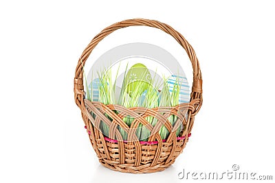 Happy Easter - few eggs on the wooden basket with a grass on the white background Stock Photo