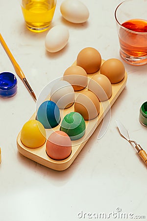 Happy Easter! Friends painting Easter eggs on table. Stock Photo