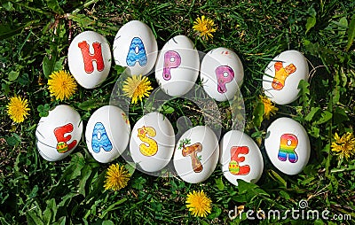Happy Easter note written on eggs on the grass Stock Photo