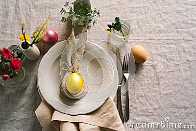 Happy Easter. Stylish easter eggs on a napkin with spring flowers on white wooden background Stock Photo