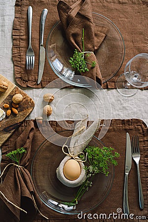 Happy Easter. Stylish easter eggs on a napkin with spring flowers on white wooden background Stock Photo