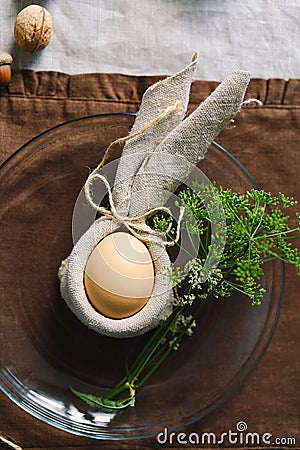 Happy Easter. Stylish easter eggs on a napkin with spring flowers on white wooden background Stock Photo